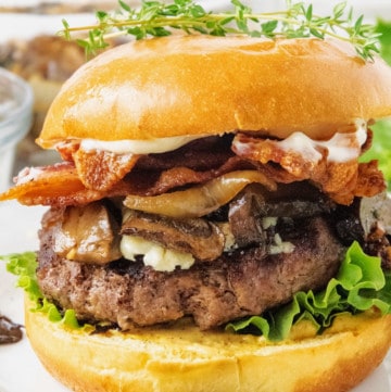 The Ultimate Steakhouse Burger is piled with roasted mushrooms, caramalized onions and crispy bacon.