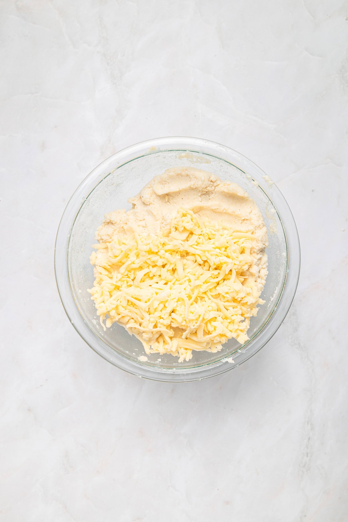 Mixing in shredded mozzarella.