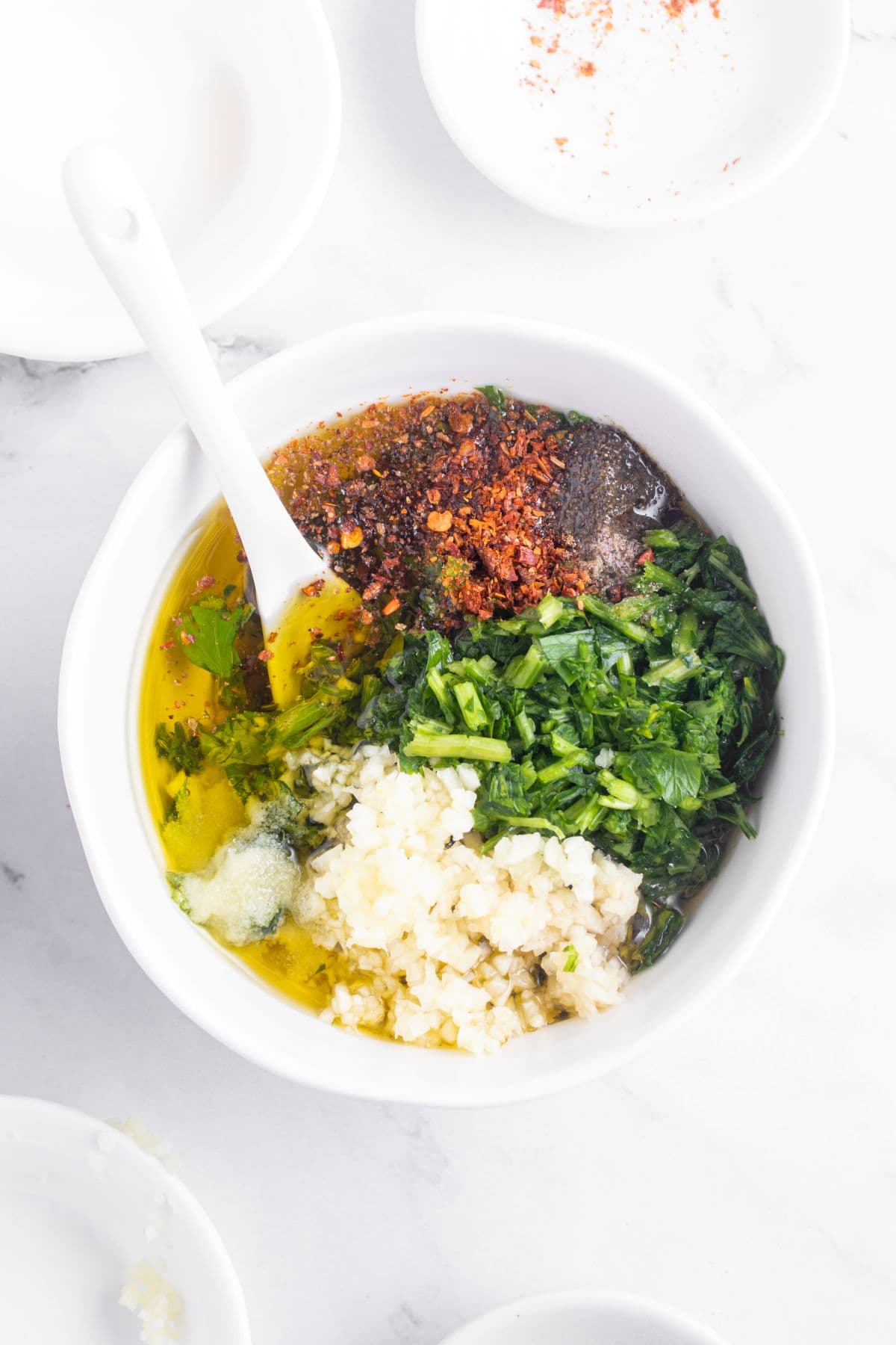 Mixing chimichurri steak sauce ingredients.