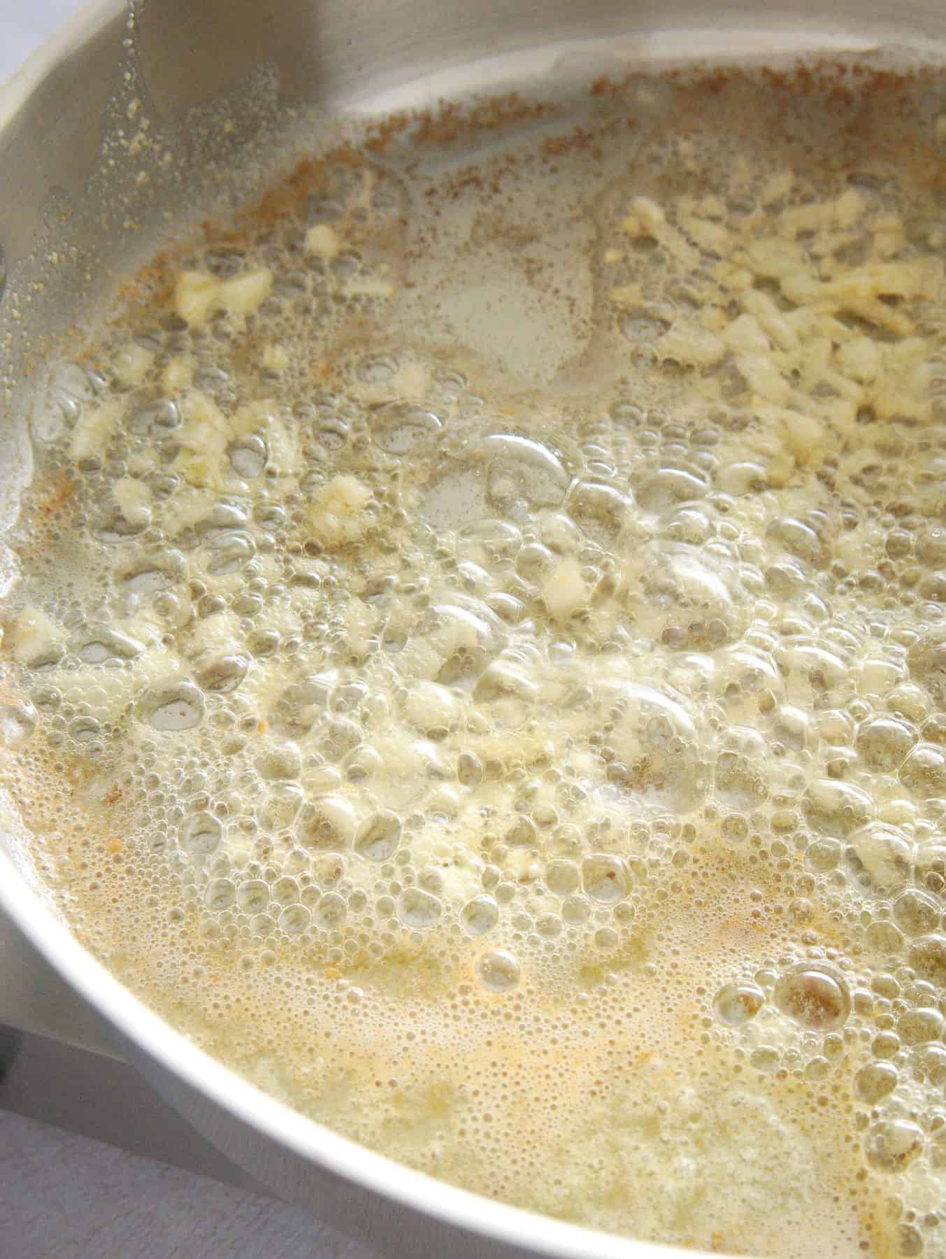 Cooking garlic in butter.
