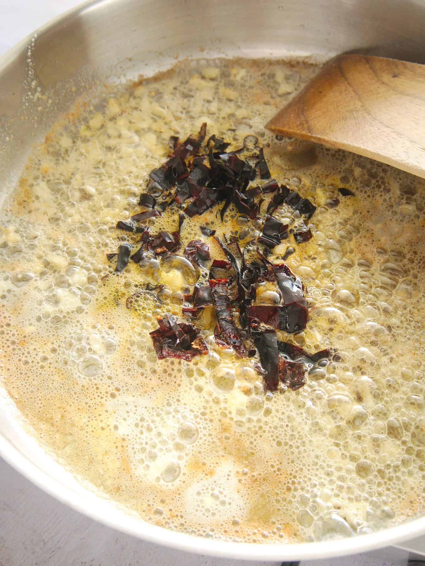 Adding chopped chilies.