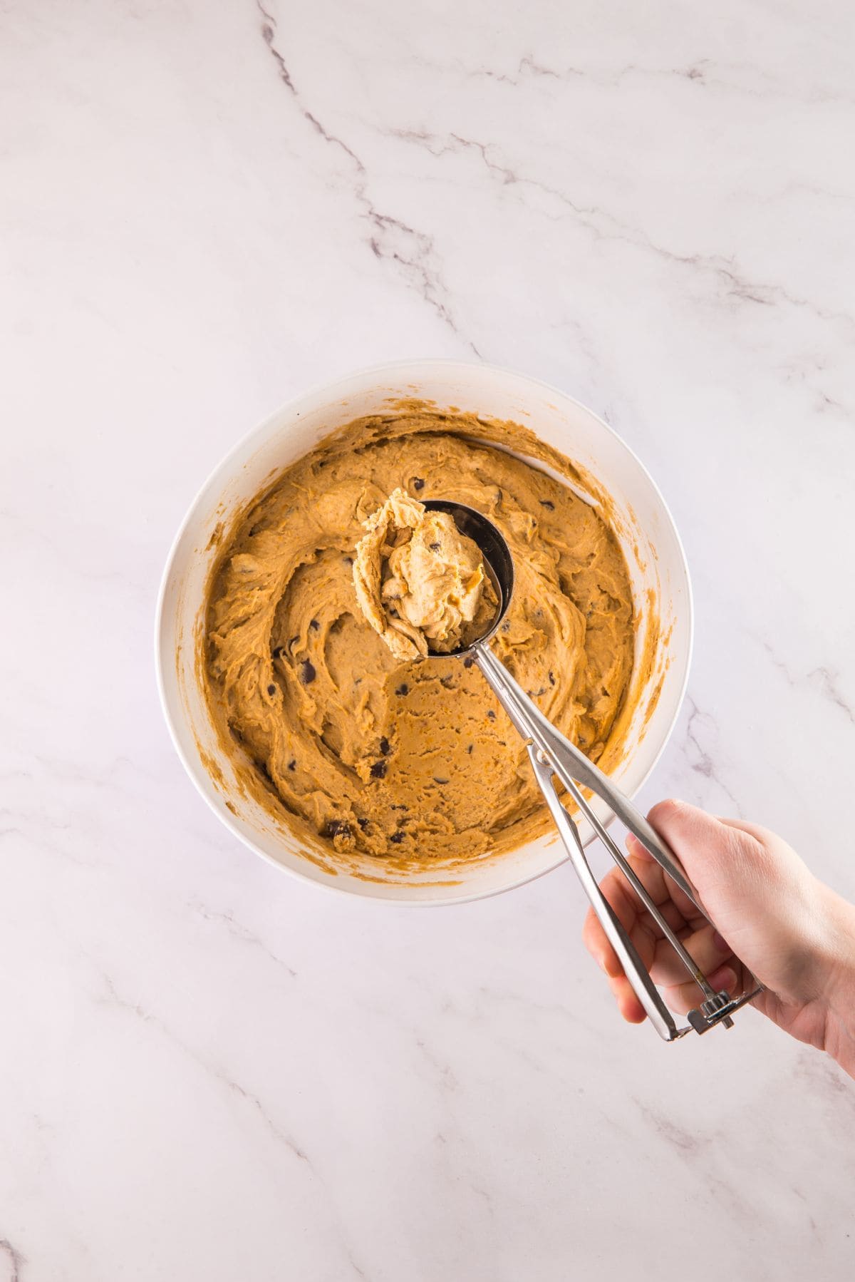 Scooping the cookie dough.