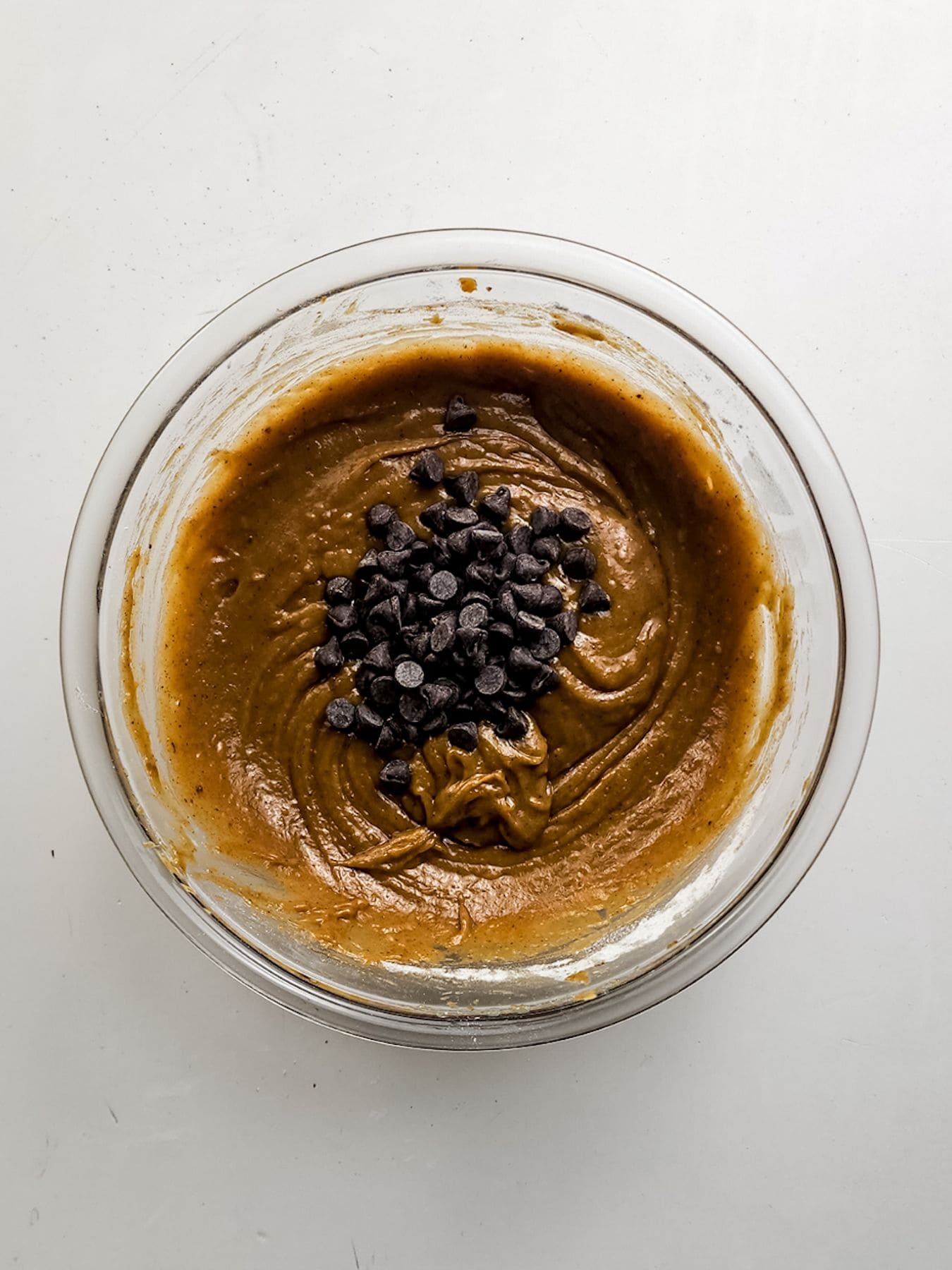 Adding chocolate chips.