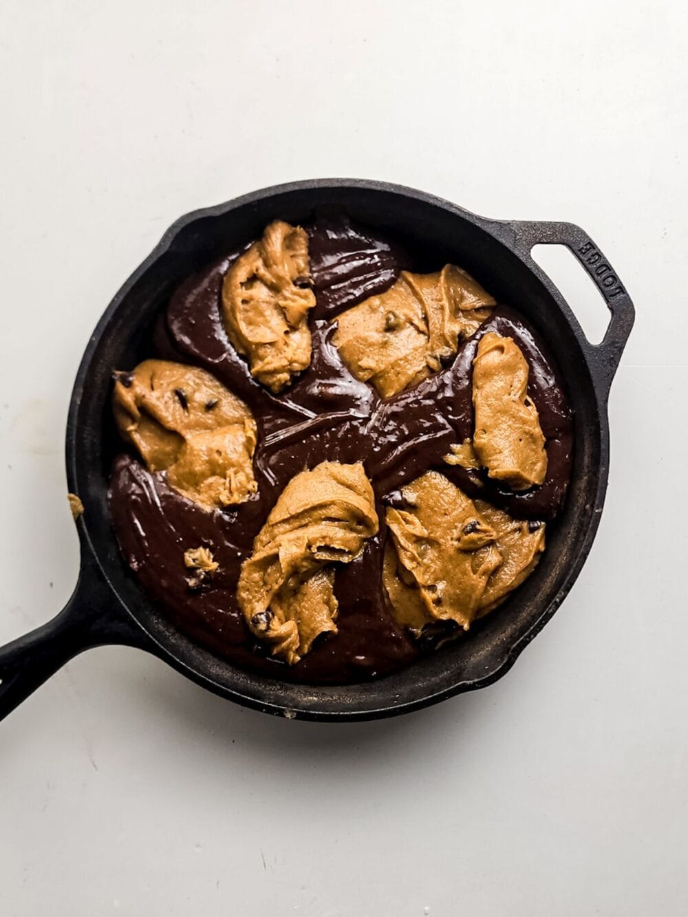 Combining brownie and pumpkin batter.