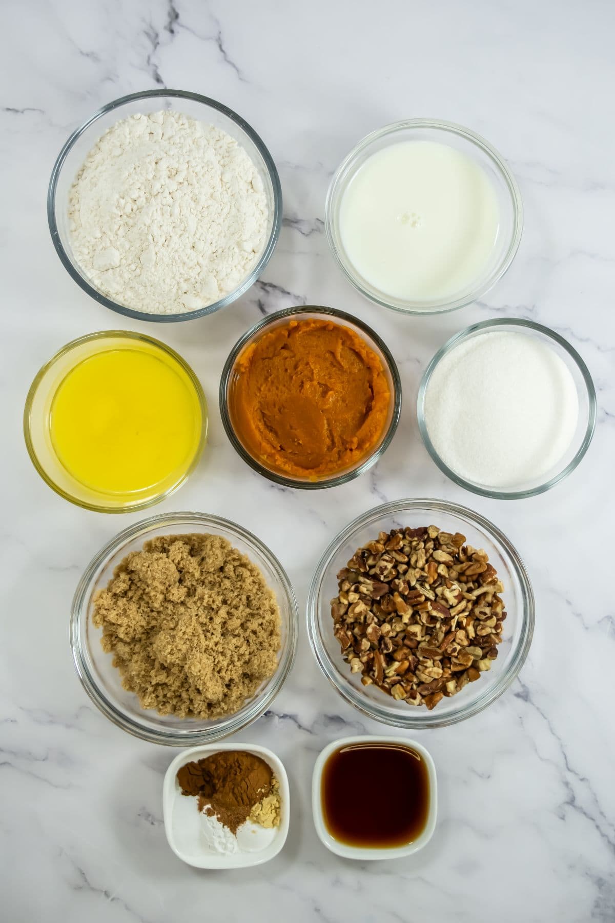 Ingredients to make pumpkin cobbler with pecan topping.