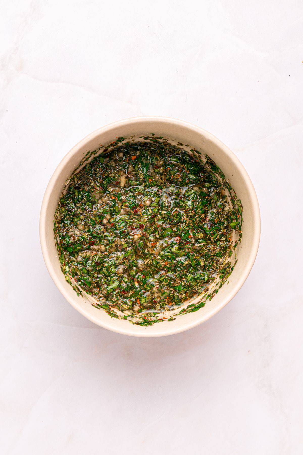 Mixing ingredients for chimichurri.