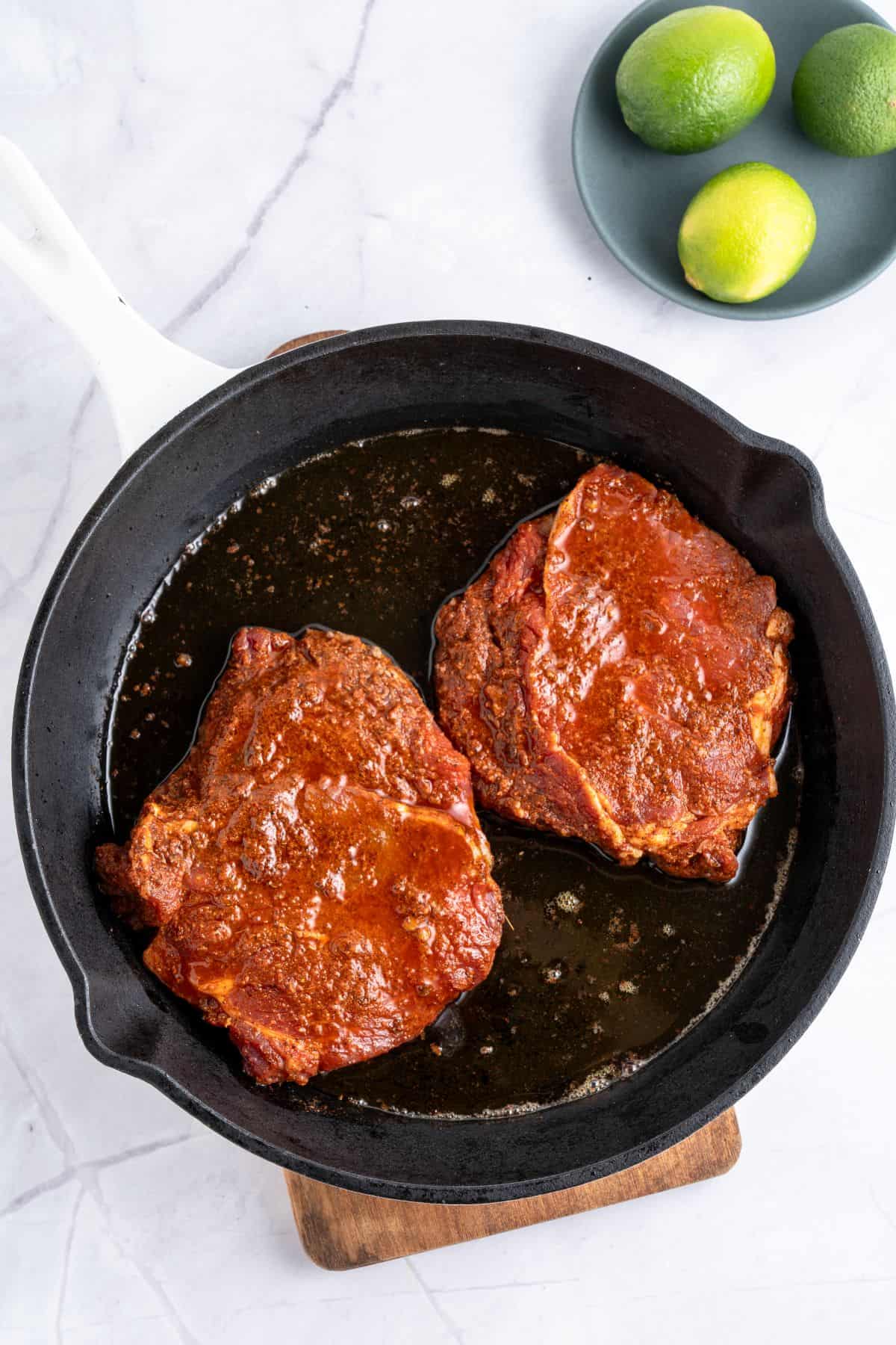 Cooking marinated steak for steak quesadillas.