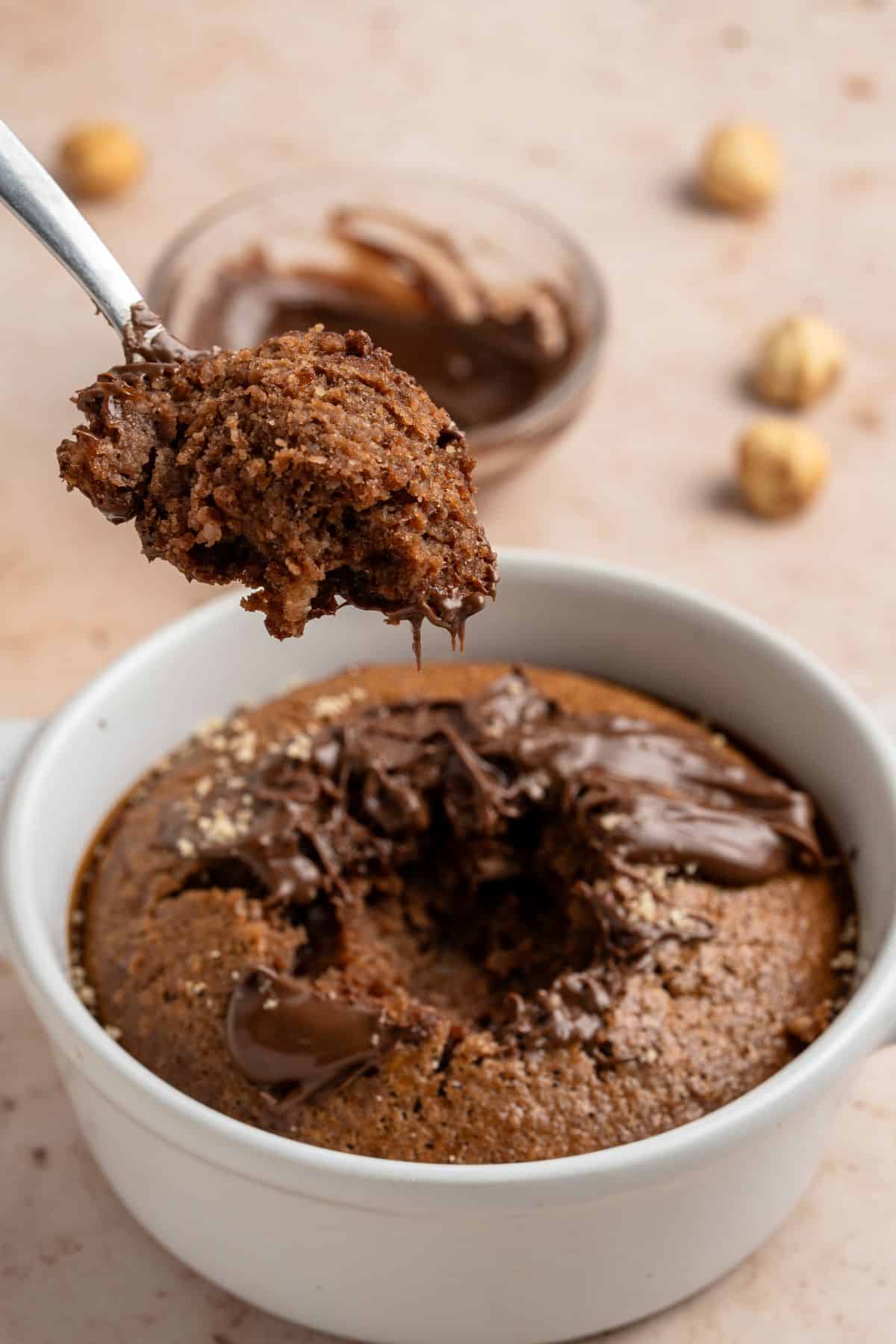 Spooning Nutella mug cake.