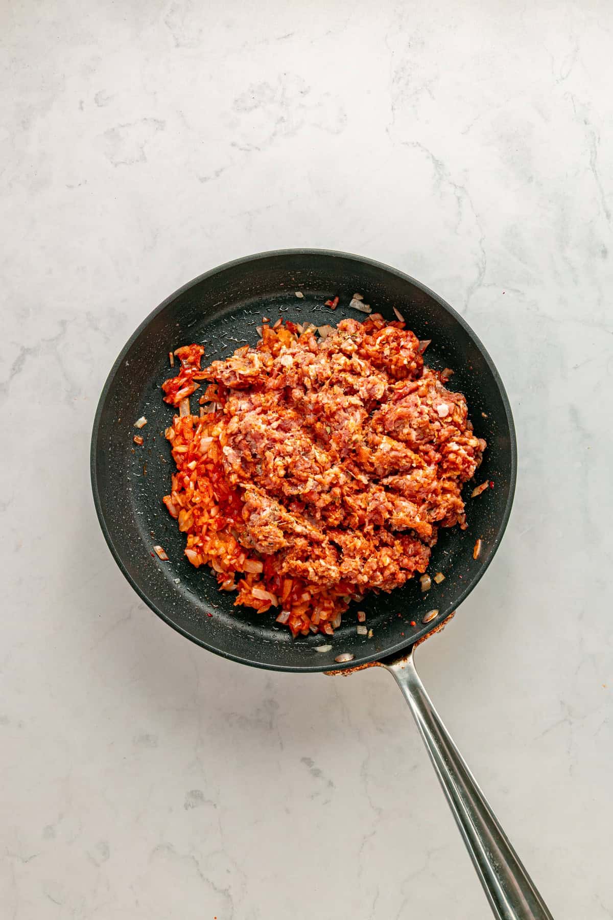 Adding raw chorizo.