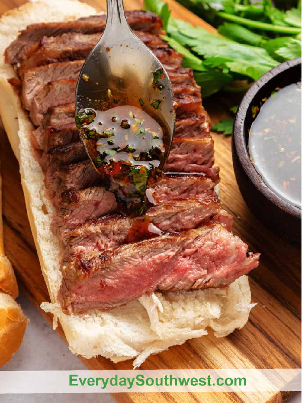 Pour a Spoon of Chimichurri Sauce on Steak Sandwich